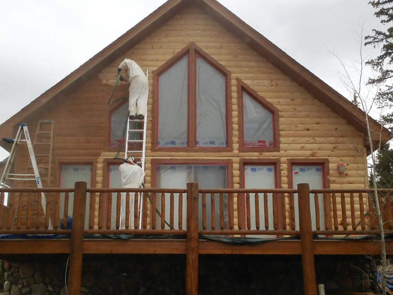 removing old finish from log home cabin with walnut shell media blasting