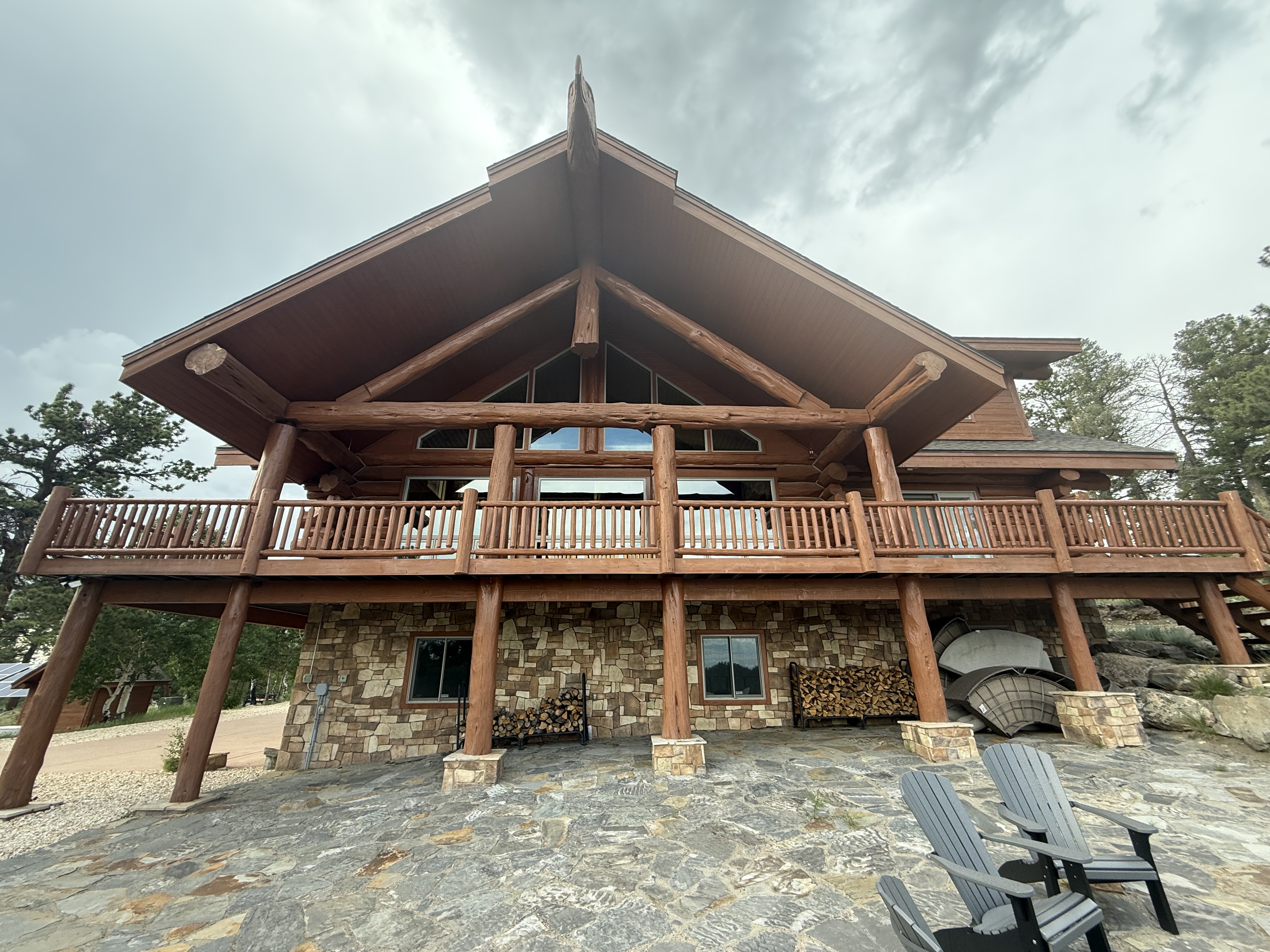 Custom log railing construction showing proper post attachment and baluster spacing